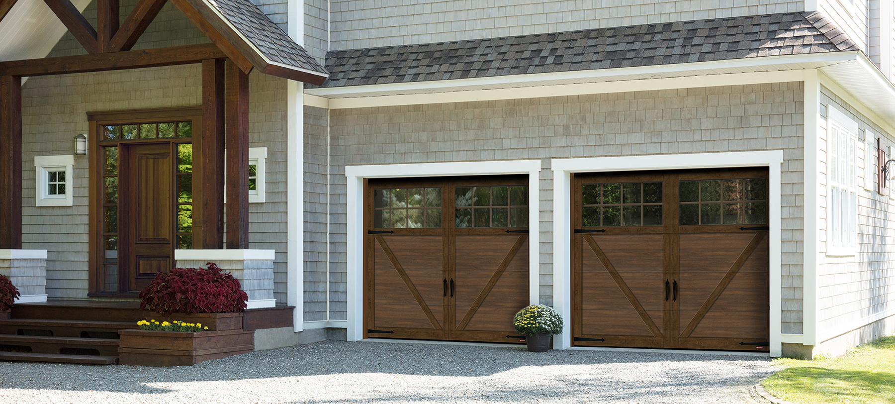Wood-tone residential garage doors on a modern Denver home