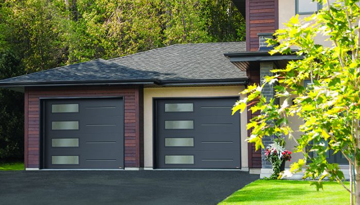 Modern black residential garage doors with window panels